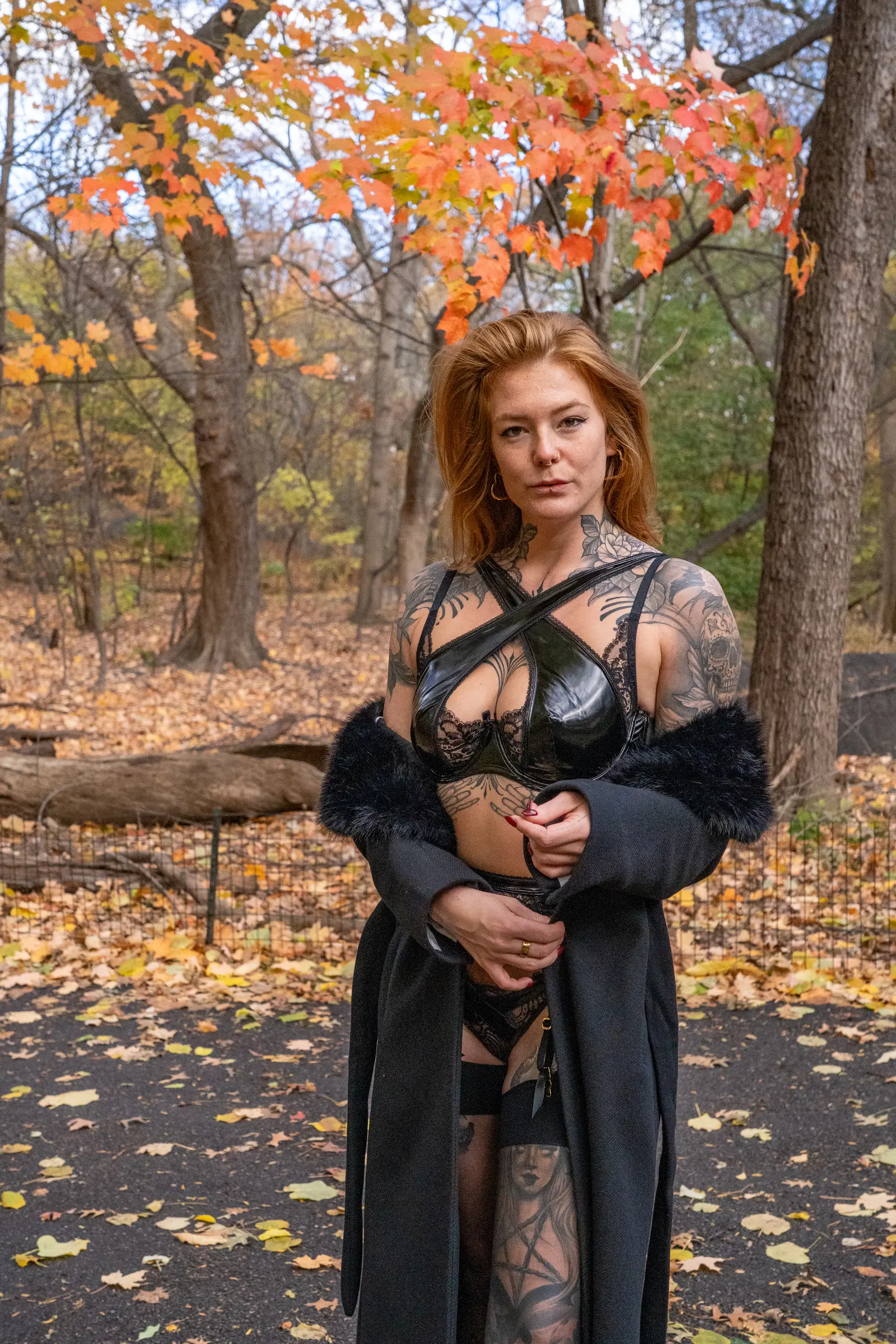 Kyana standing in an autumn park, calm and unapologetic